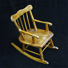 Rocking chair, or rocker, made of wood.
