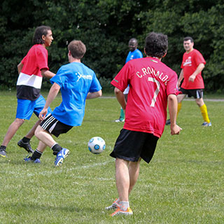 Two groups of men compete for the ball during a soccer game.