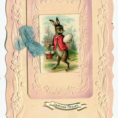 Carte de souhaits pour Pâques où l'on voit un lapin, vêtu d'un veston rouge, porter un gros oeuf et un panier rempli d'oeufs.