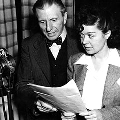 A man (Hector Charland) and a woman (Estelle Mauffette) while recording an episode of the radio serial drama.